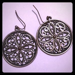 Francesca’s silver earrings w floral type design.